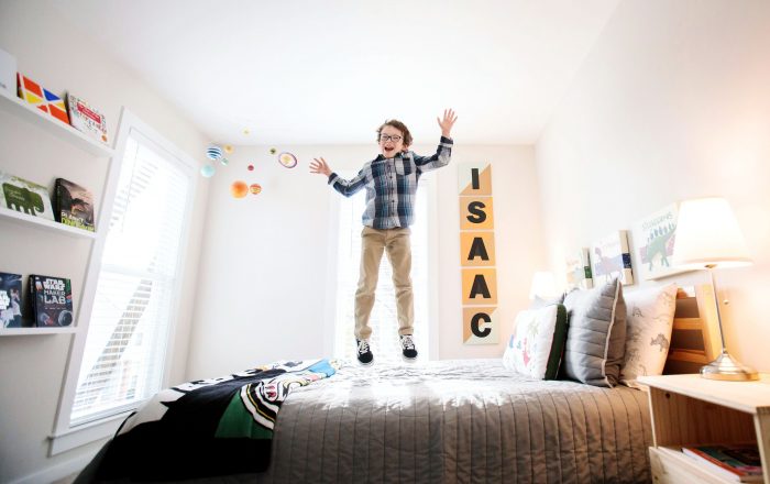 Boy jumping on his bed