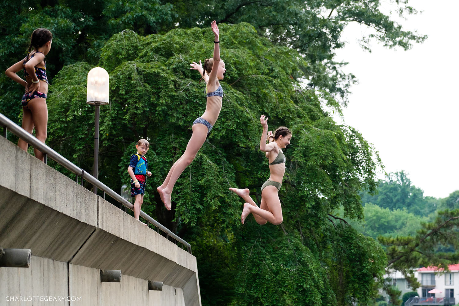 Girls jumping into Lake Anne (Reston, Virginia)